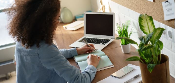 Woman in front of laptop taking training